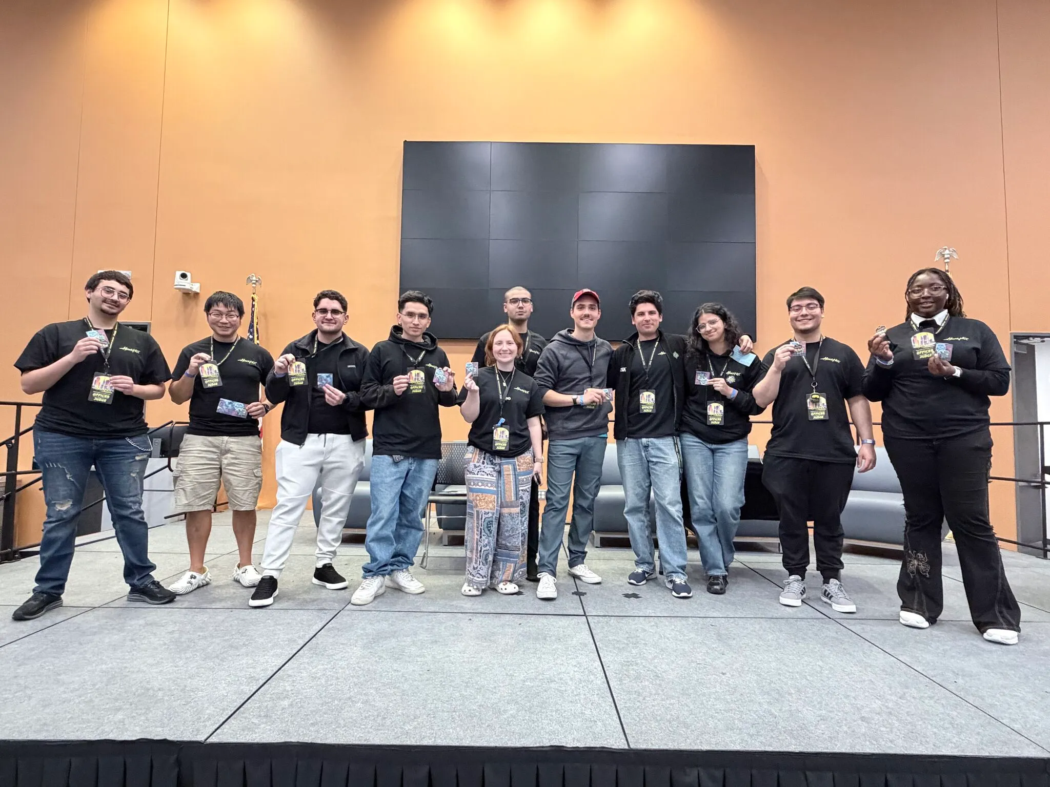 HackHCC officers and judges lined up on stage at the Code Runners 2026 closing ceremony